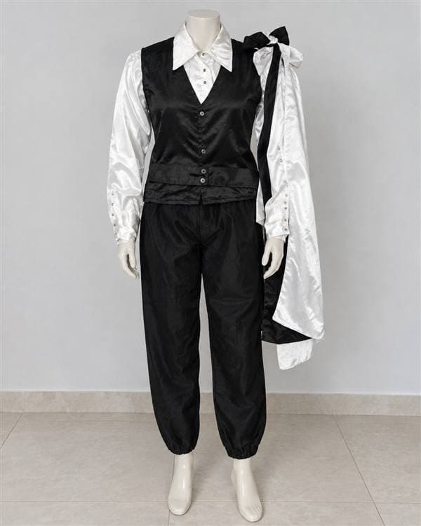 Rey (chaleco negro, camisa blanca)